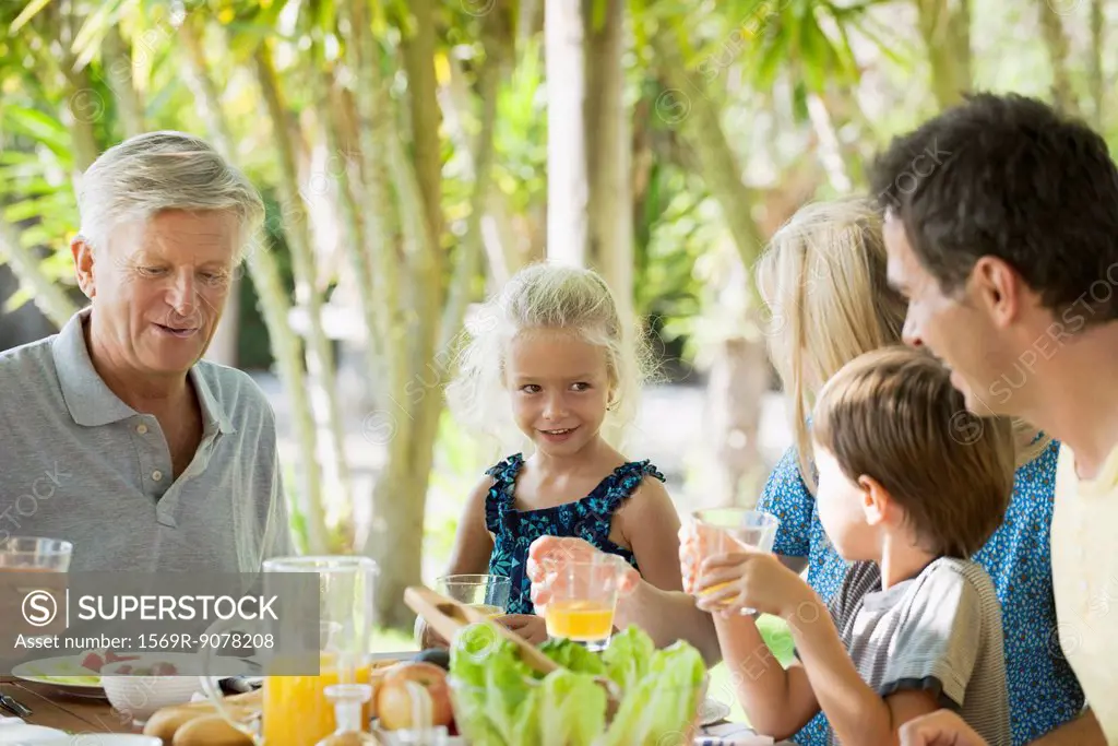 Multi_generation family having breakfast outdoors