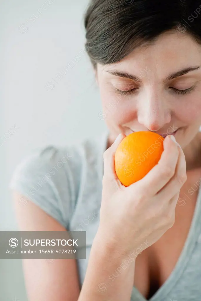 Woman smelling fresh orange