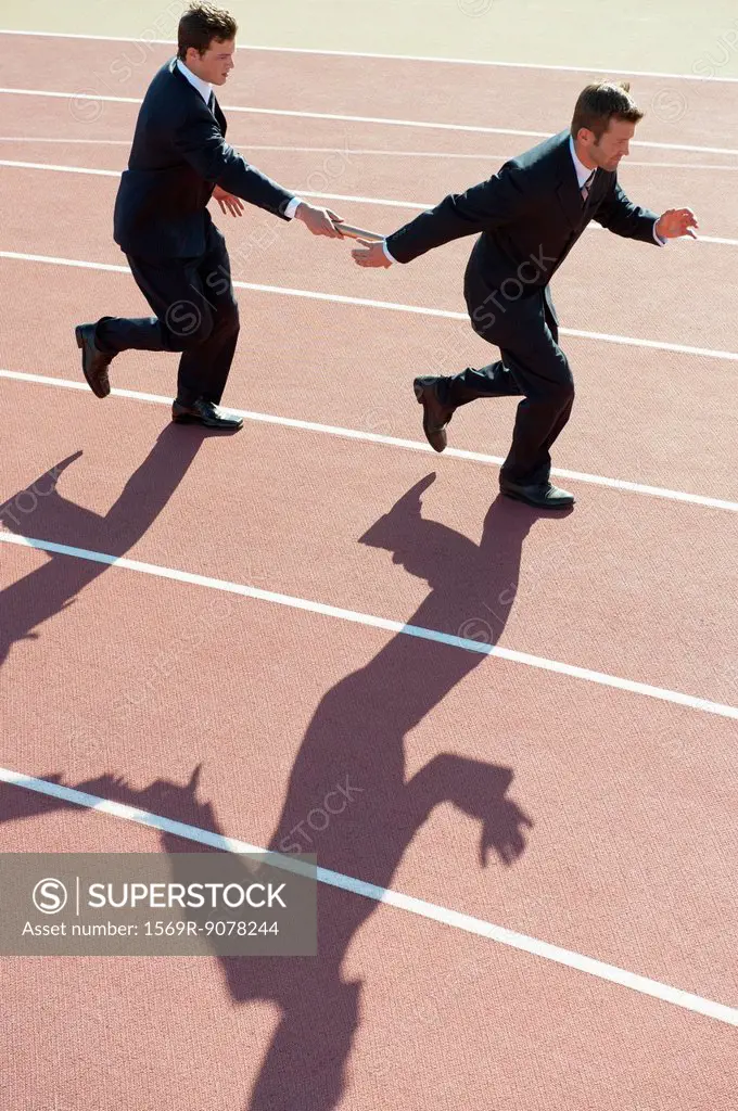Businessmen running relay race