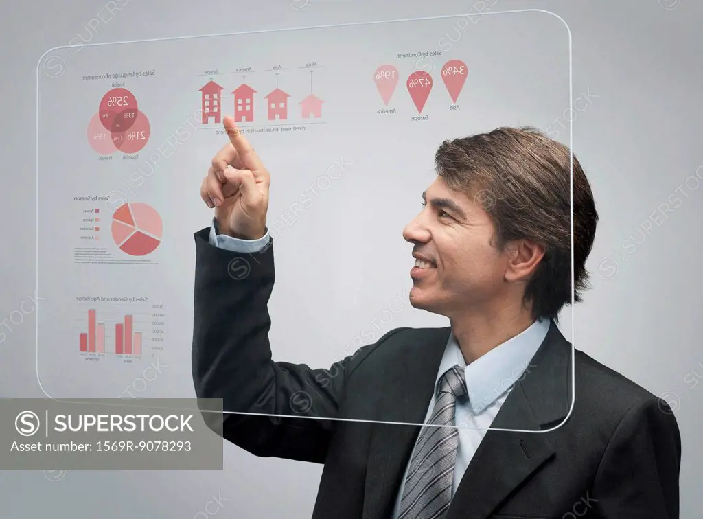 Businessman using advanced touch screen technology to view sales data
