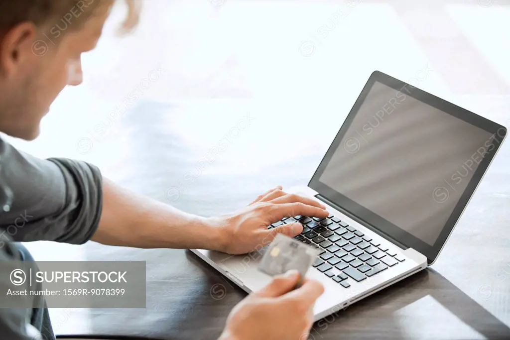 Man using credit card to make an online purchase