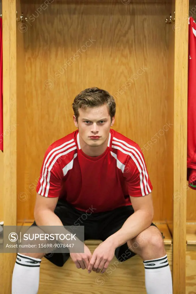 Soccer player sitting in locker room