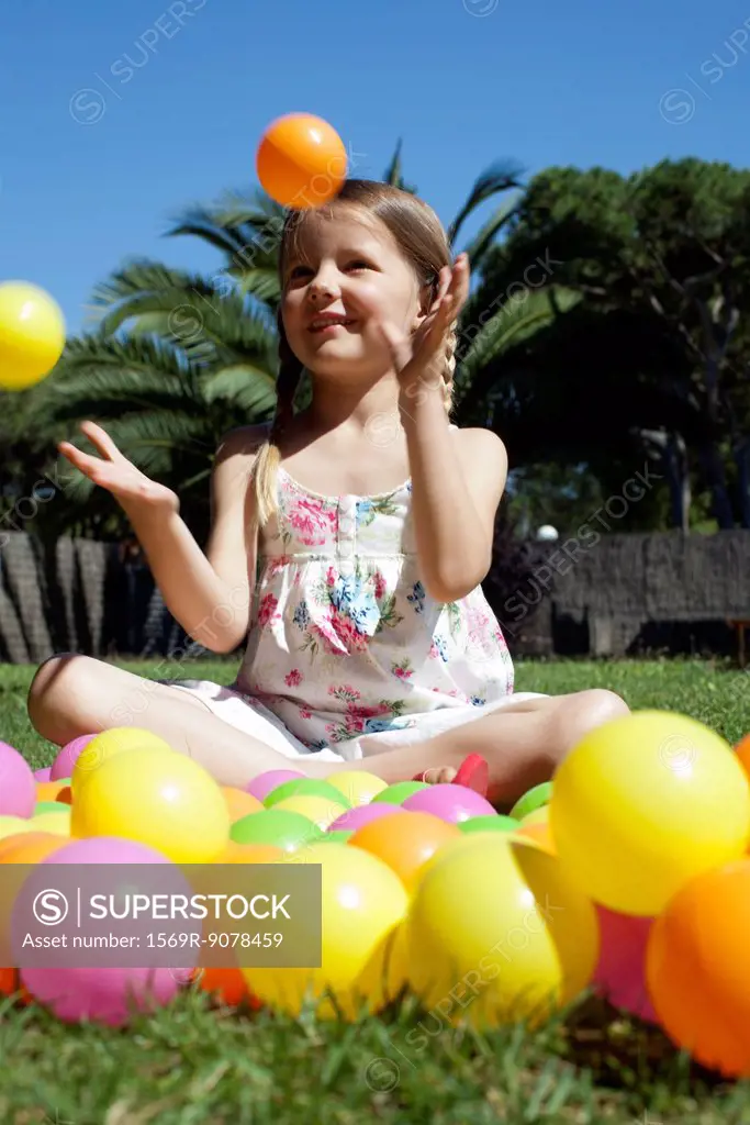 Girl playing with plastic balls