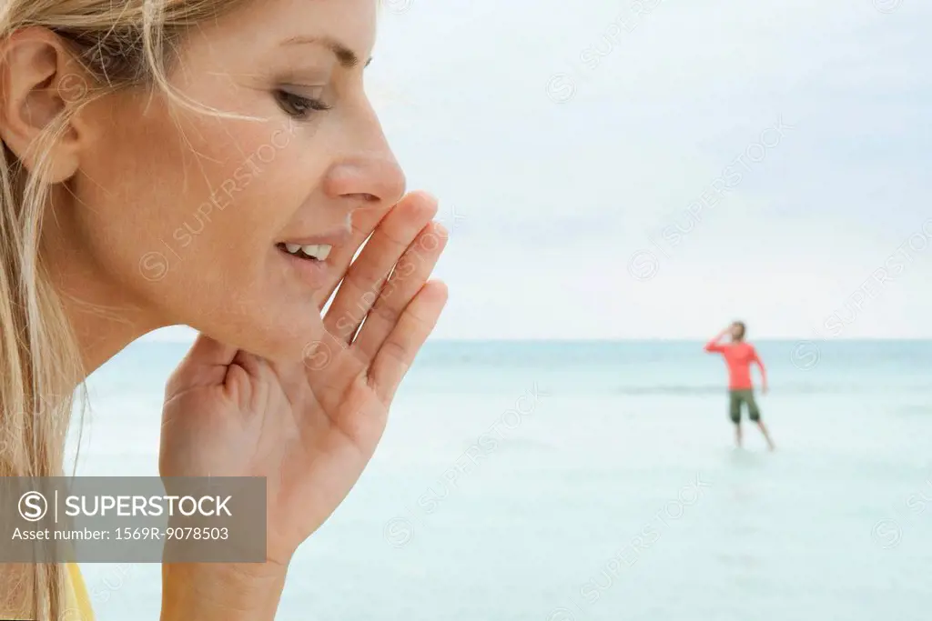 Woman appearing to whisper to tiny man