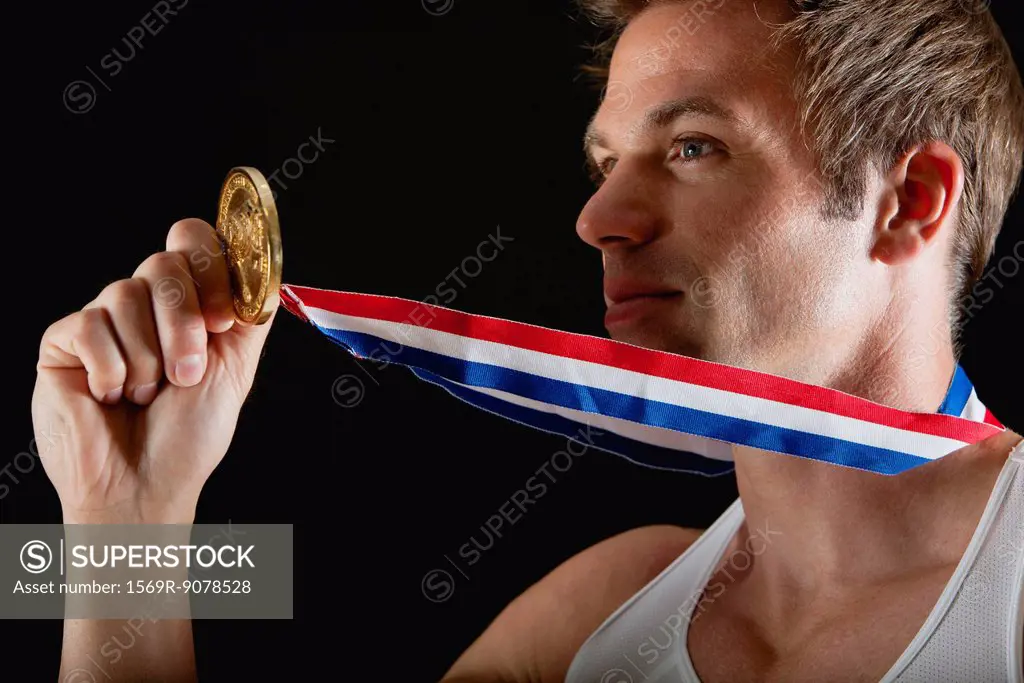 Athlete holding gold medal