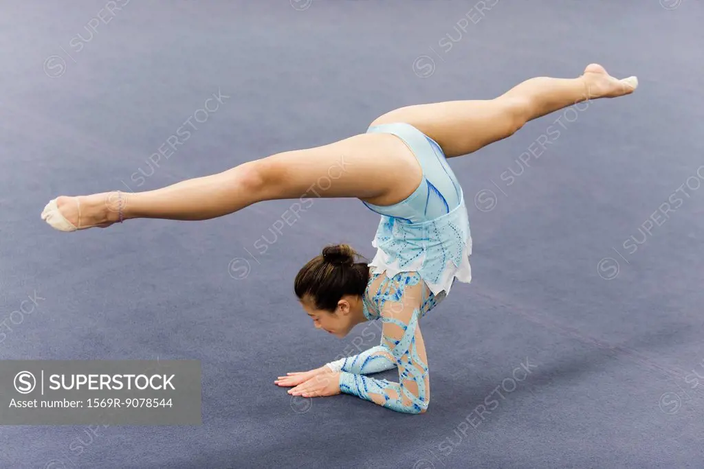 Female gymnast performing elbow stand