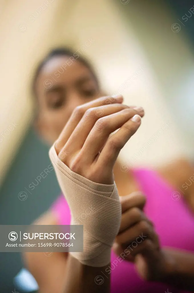 Woman with hand wrapped with bandage, low angle view