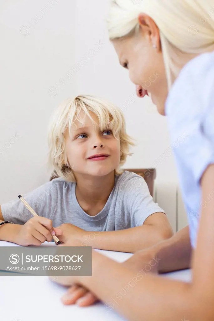 Mother helping son with homework