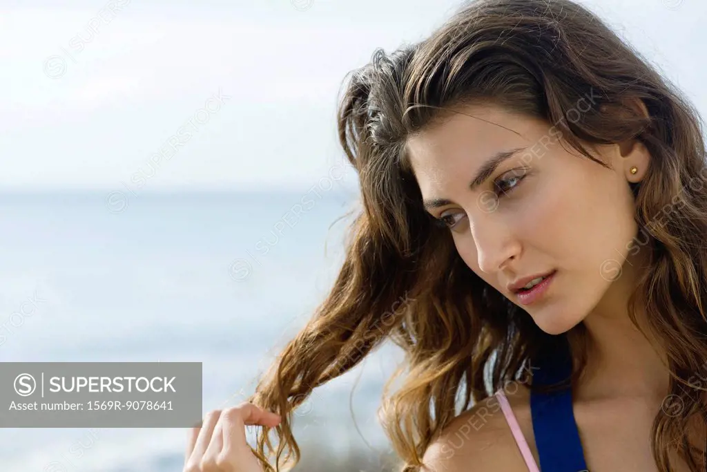 Young woman daydreaming outdoors, portrait