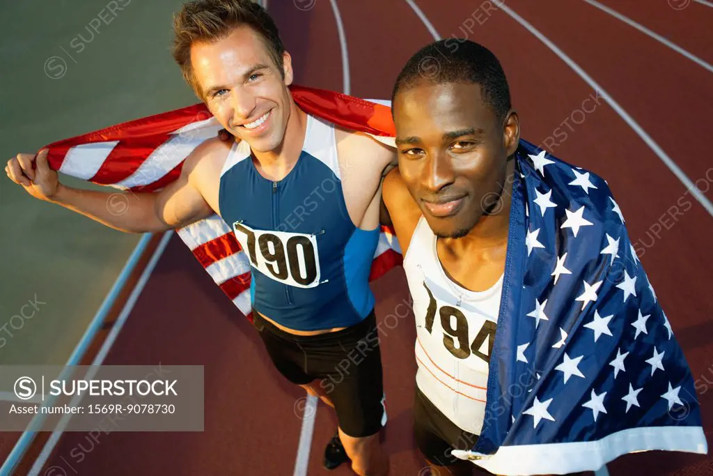 Running teammates holding up American flag after race