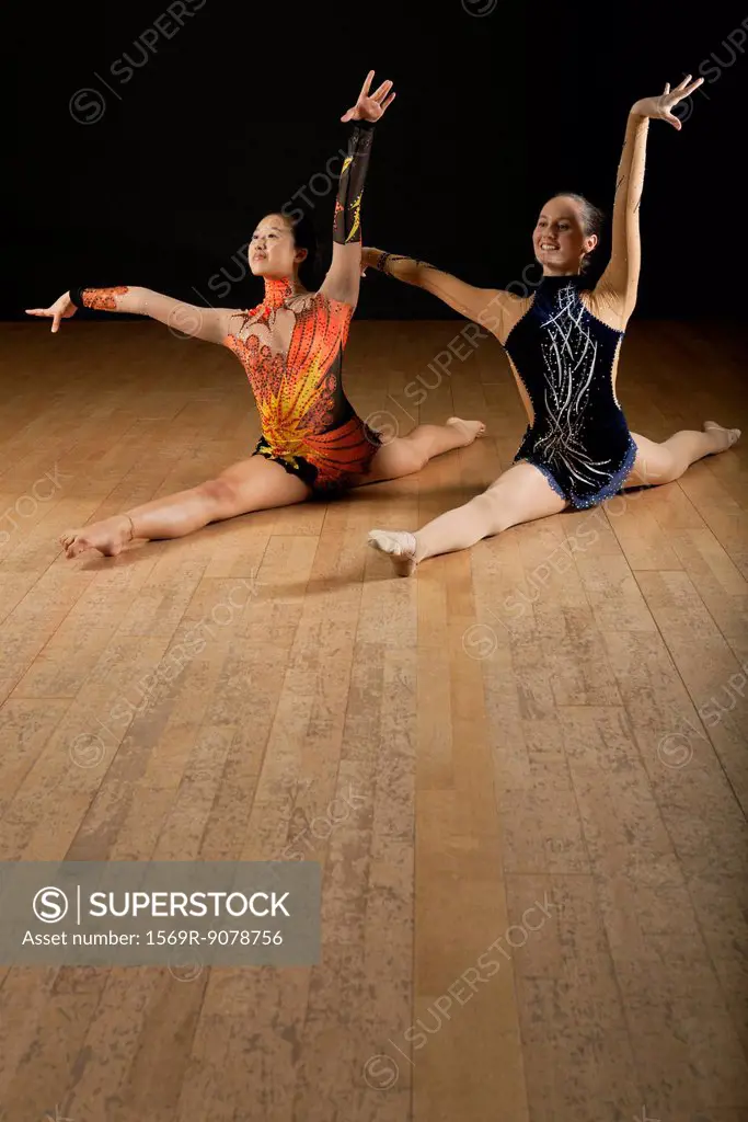 Gymnasts performing splits together