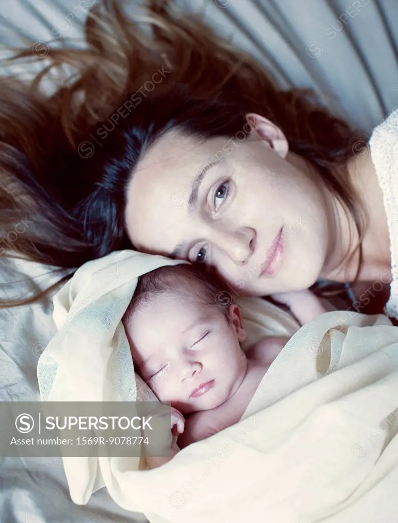 Mother and her sleeping new born baby, portrait