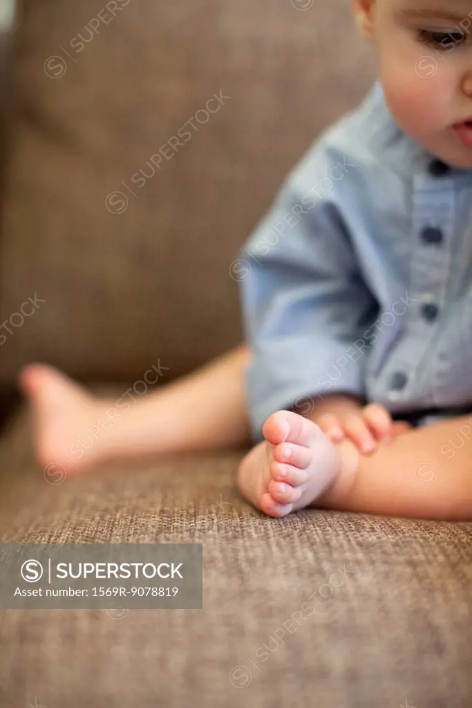 Baby boy sitting, cropped