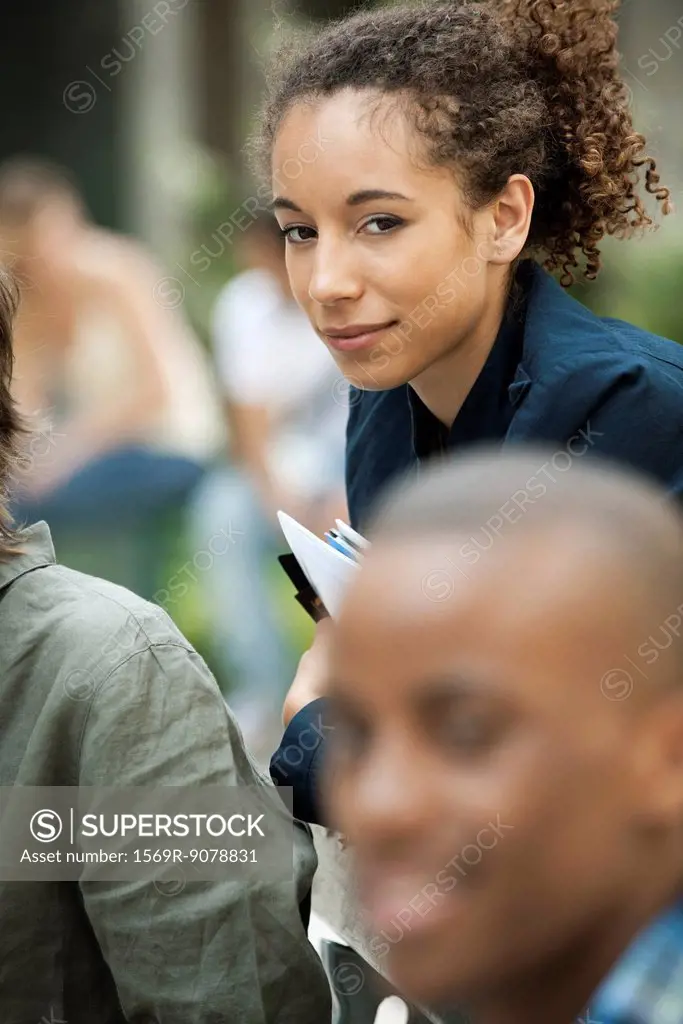 Young woman with friends, focus on one person