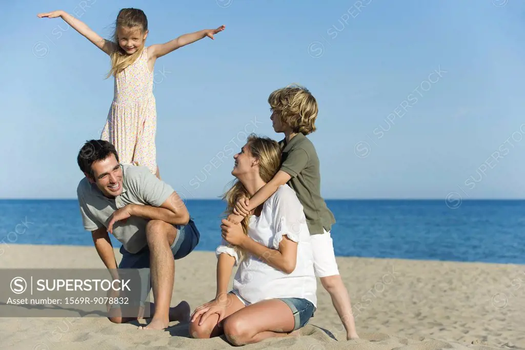 Family playing together at the beach