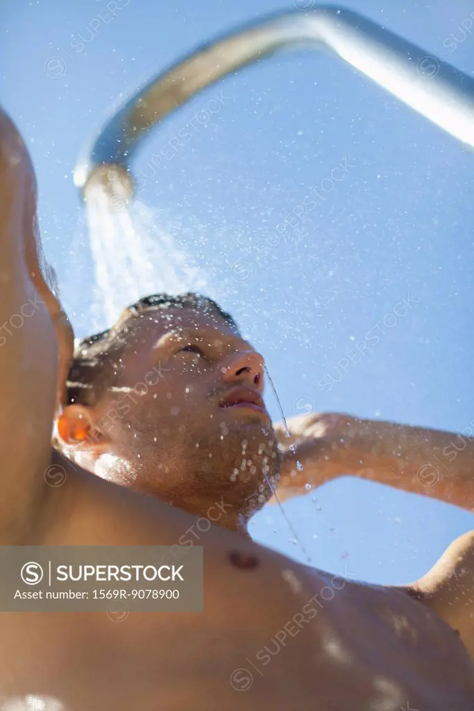 Man using outdoor shower