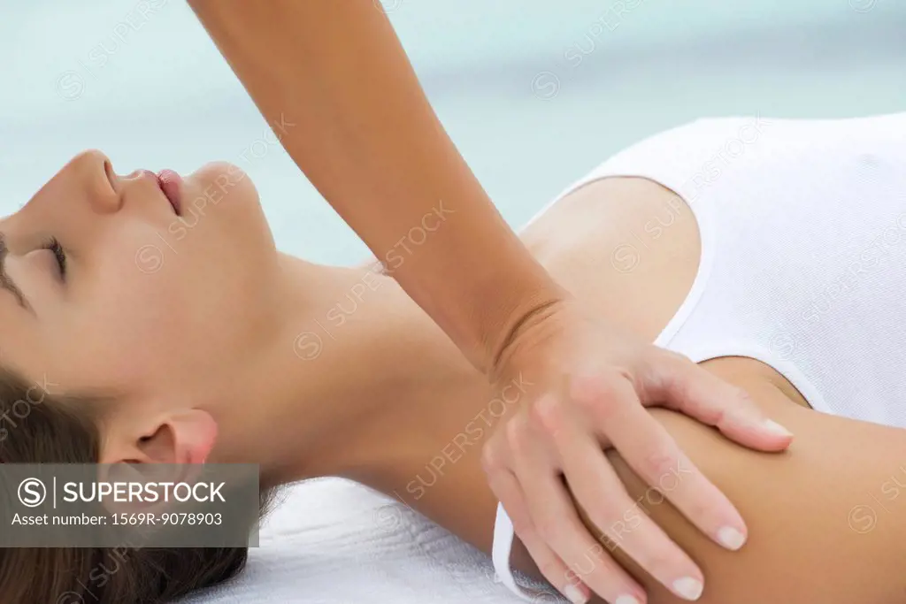 Young woman receiving massage, side view