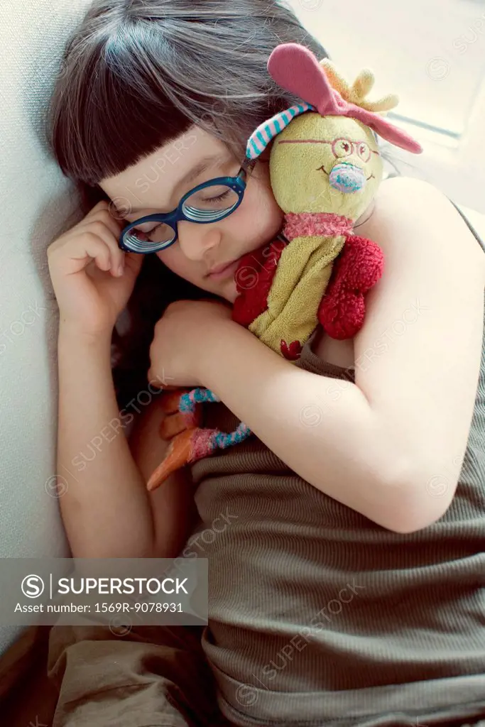 Girl napping with stuffed toy