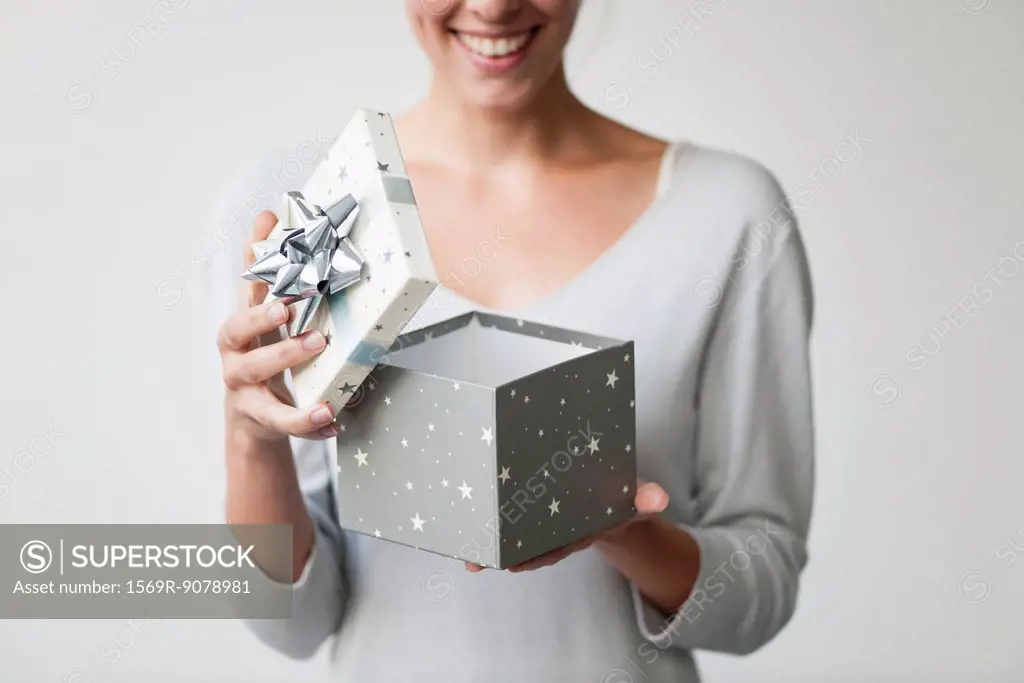 Woman opening gift box, cropped