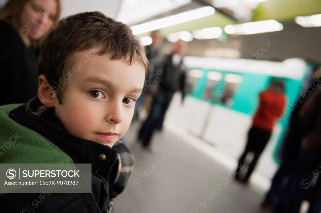 Boy waiting for train in subway station