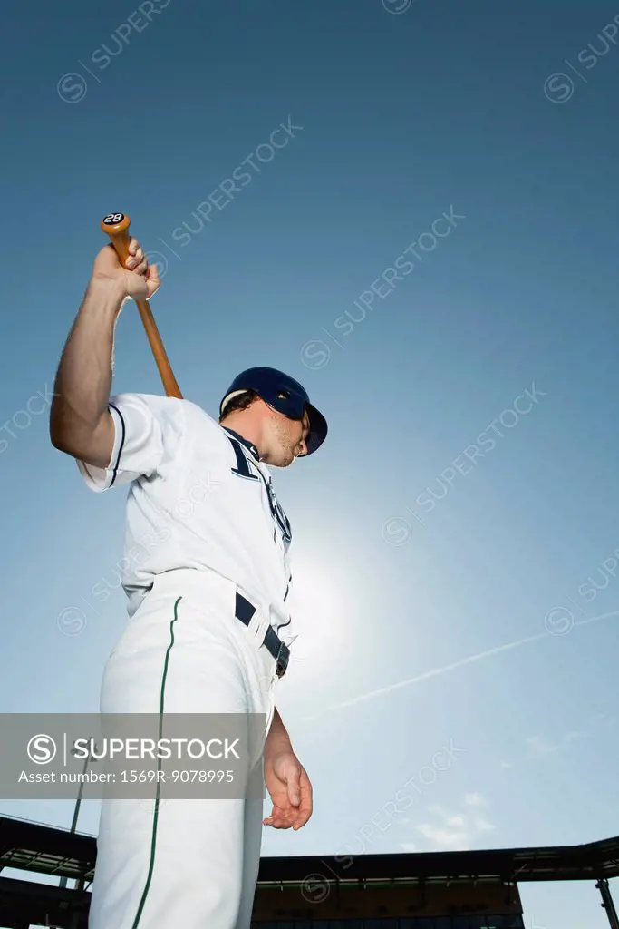 Baseball player holding baseball bat across shoulders