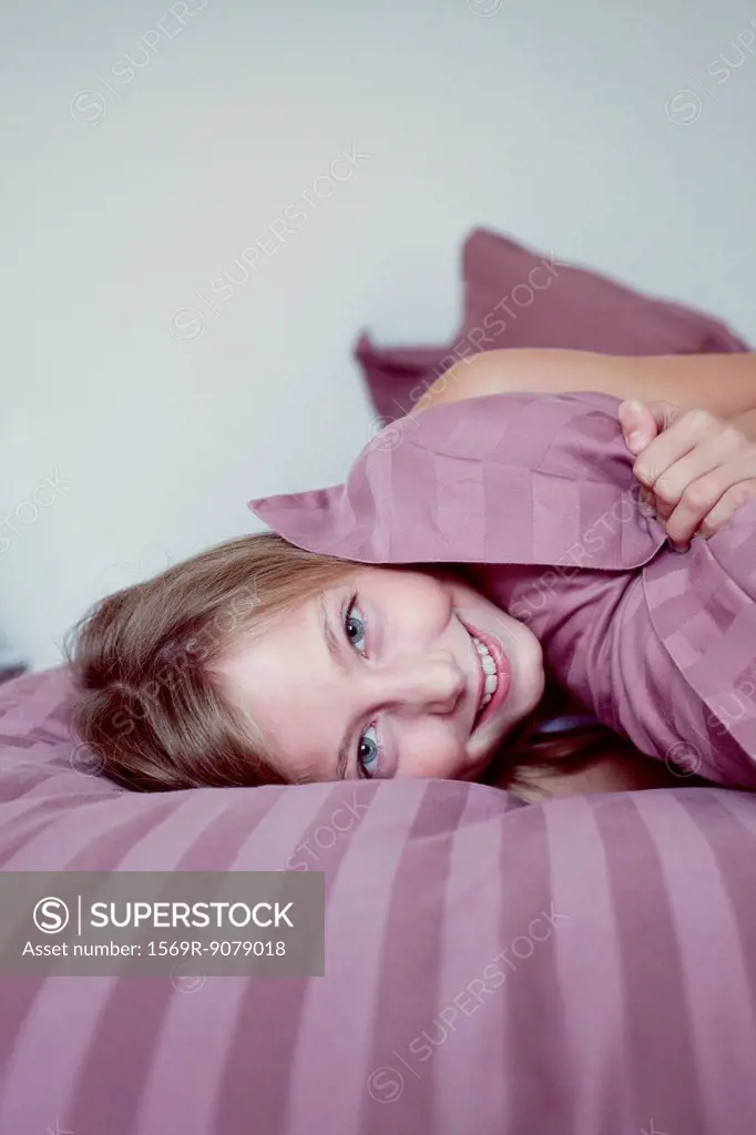 Girl lazing around on bed