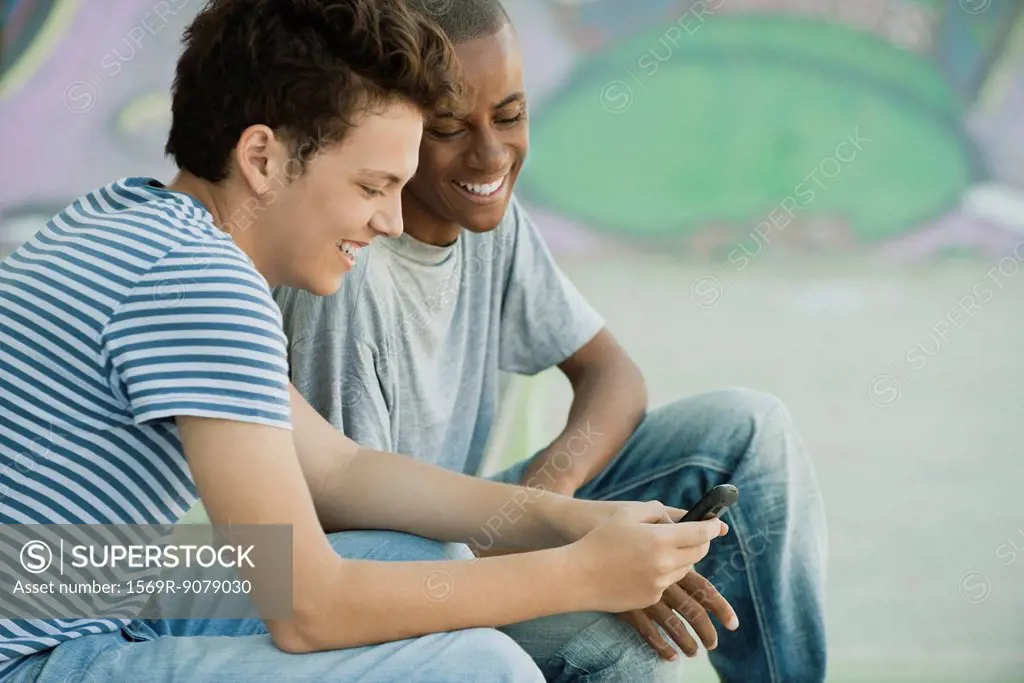 Young men looking at cell phone