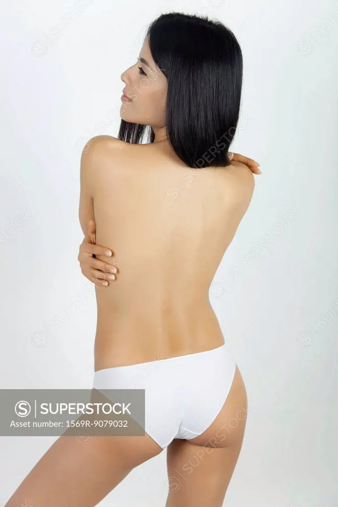 Woman standing in underwear, rear view