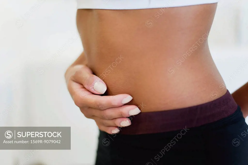 Woman holding stomach, mid section