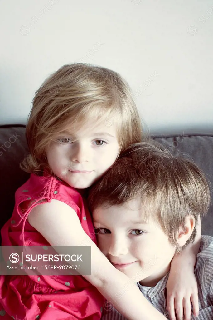 Young brother and sister embracing, portrait