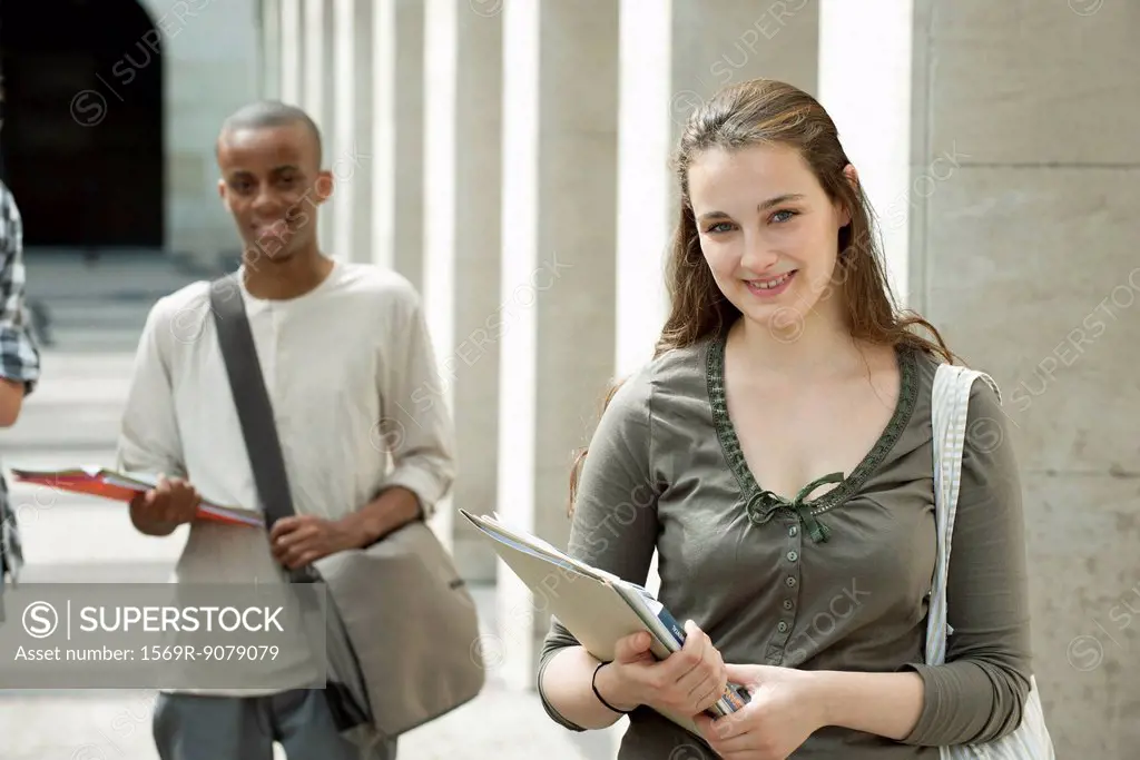 University students on campus, focus on woman in foreground