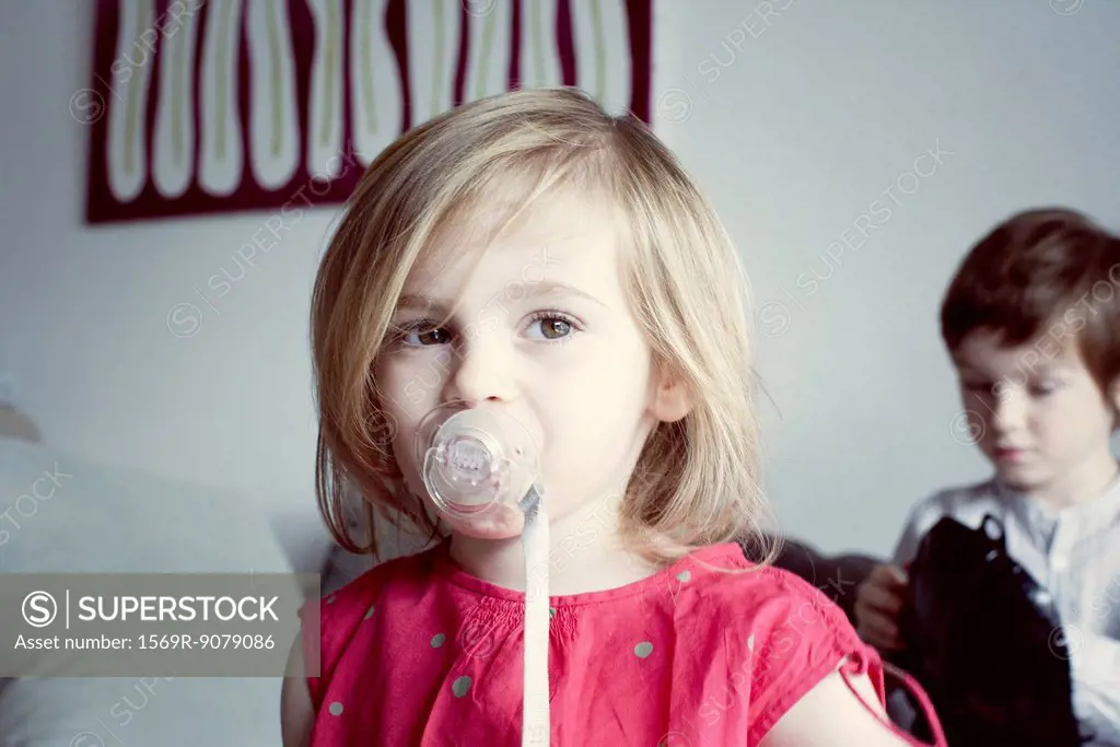 Little girl sucking pacifier