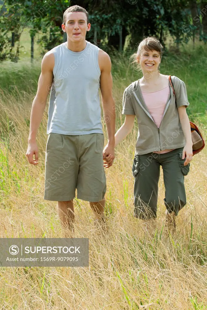 Young couple going for hike, holding hands