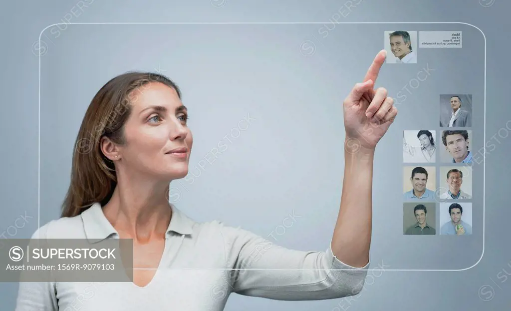 Woman using internet dating service on advanced touch screen interface