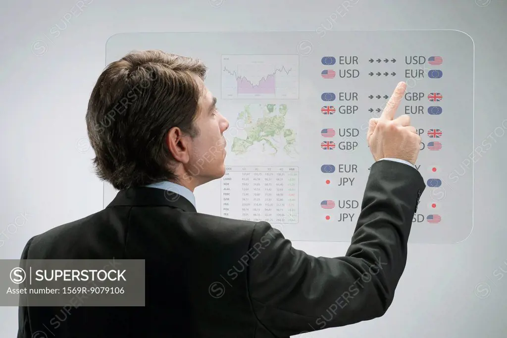 Businessman using advanced touch screen technology to view business data