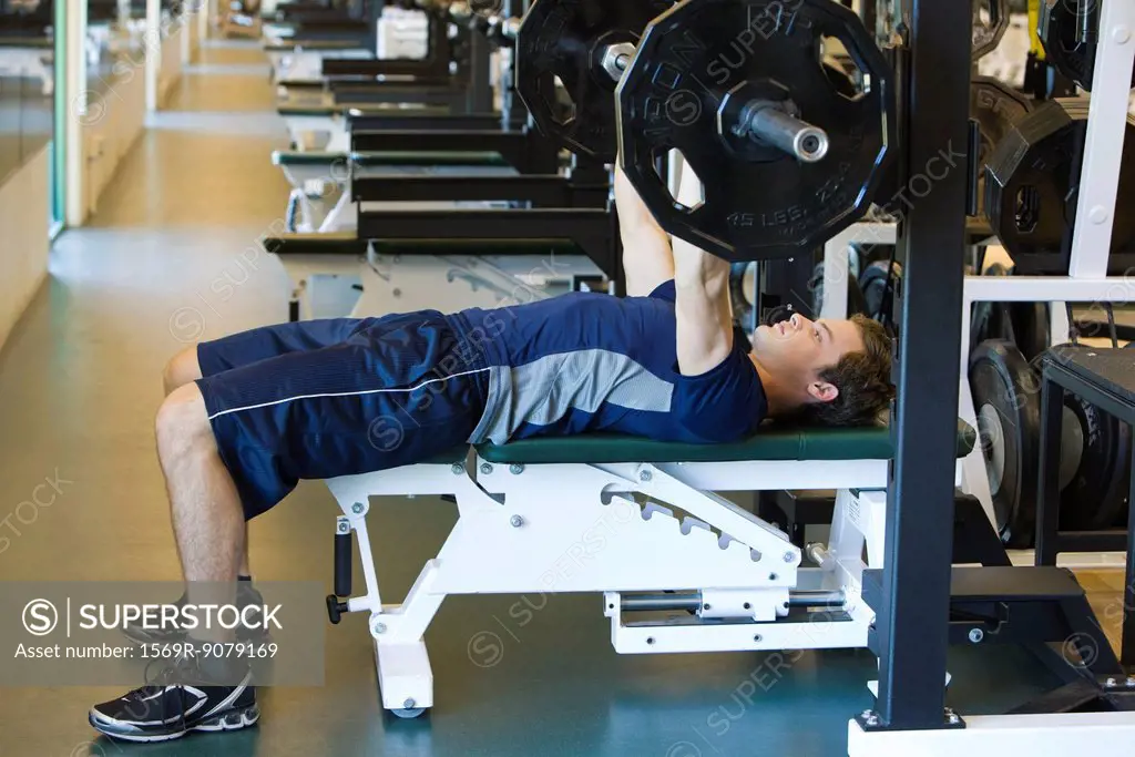 Young man lifting weights