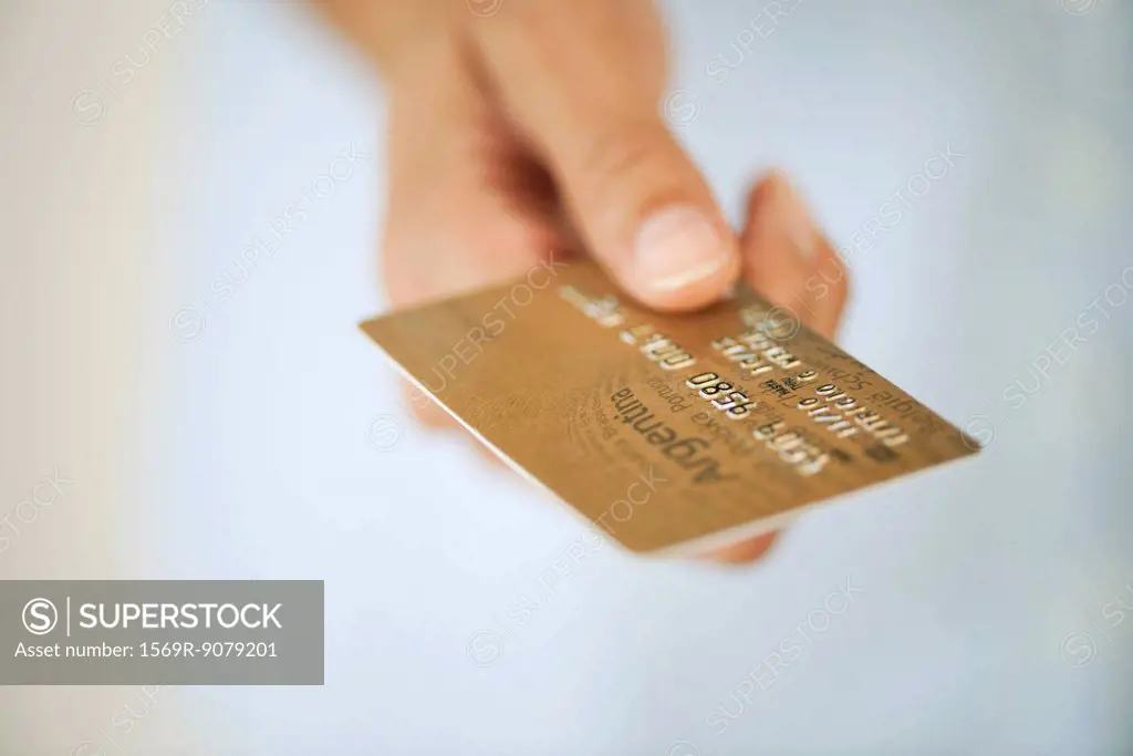 Hand holding credit card, cropped