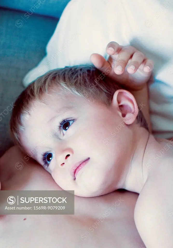 Little boy resting head on his brother´s chest, portrait
