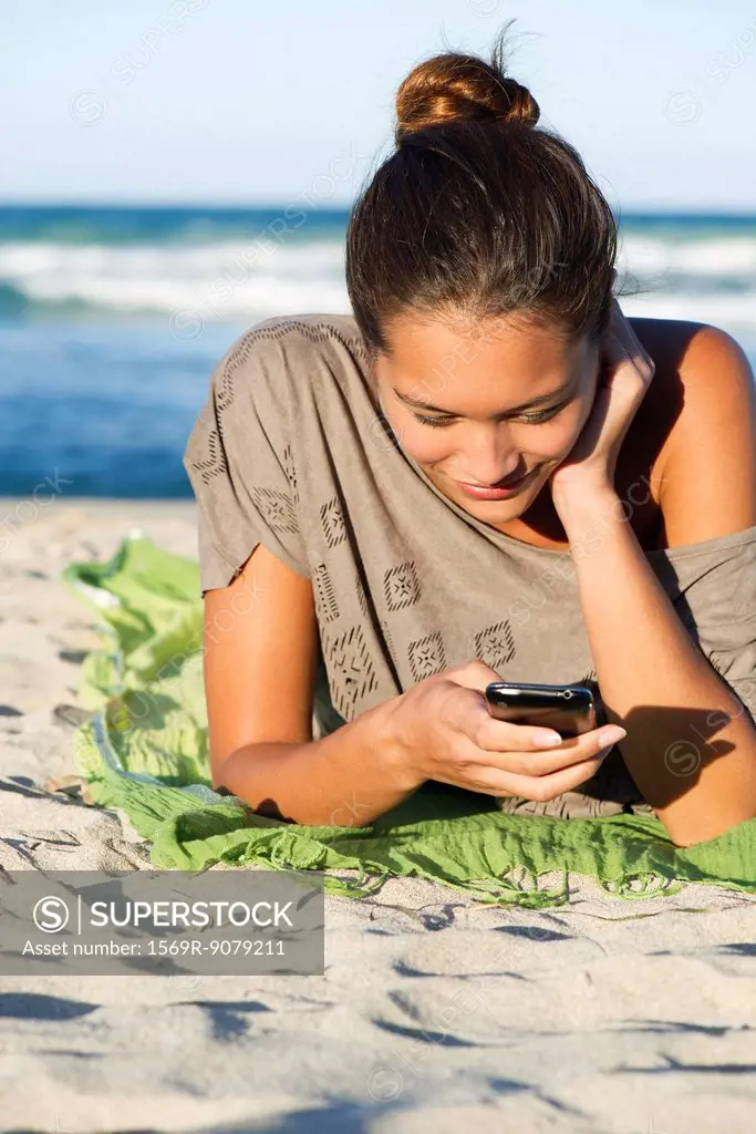 Woman text messaging on beach