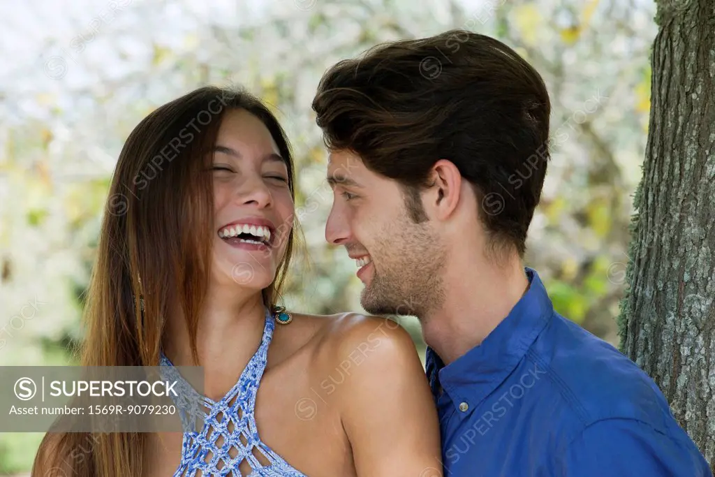 Young couple laughing, portrait