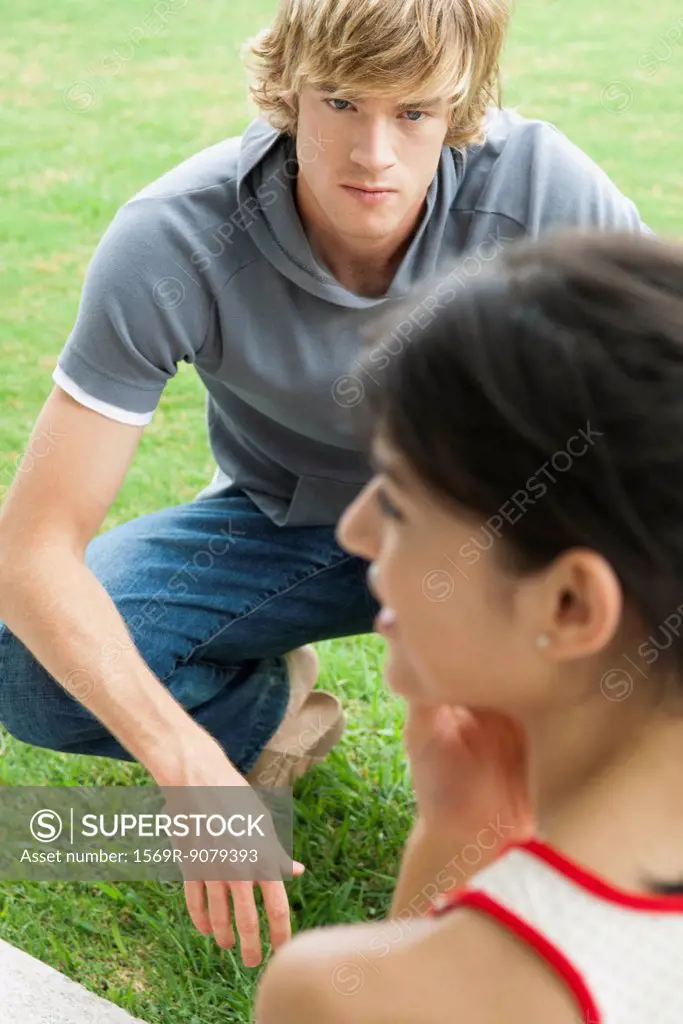 Young man hanging out outdoors with female friend