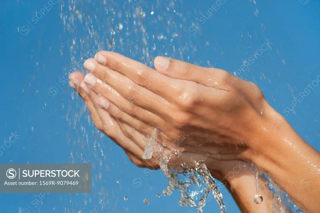 Hands under splashing water