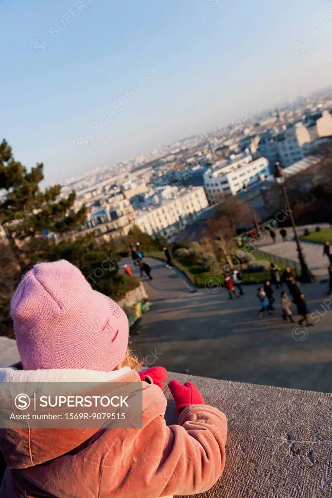 Little girl looking at view of city, Montmartre, Paris, France