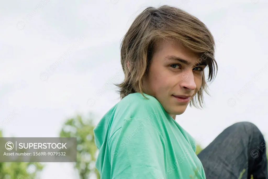 Young man relaxing outdoors, portrait