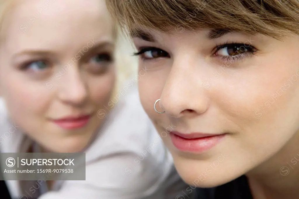 Young woman with friend, smiling, portrait