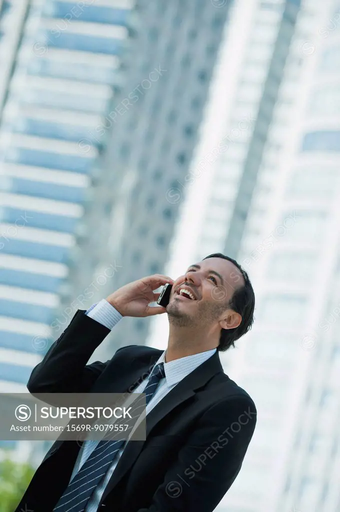 Business executive using cell phone outdoors