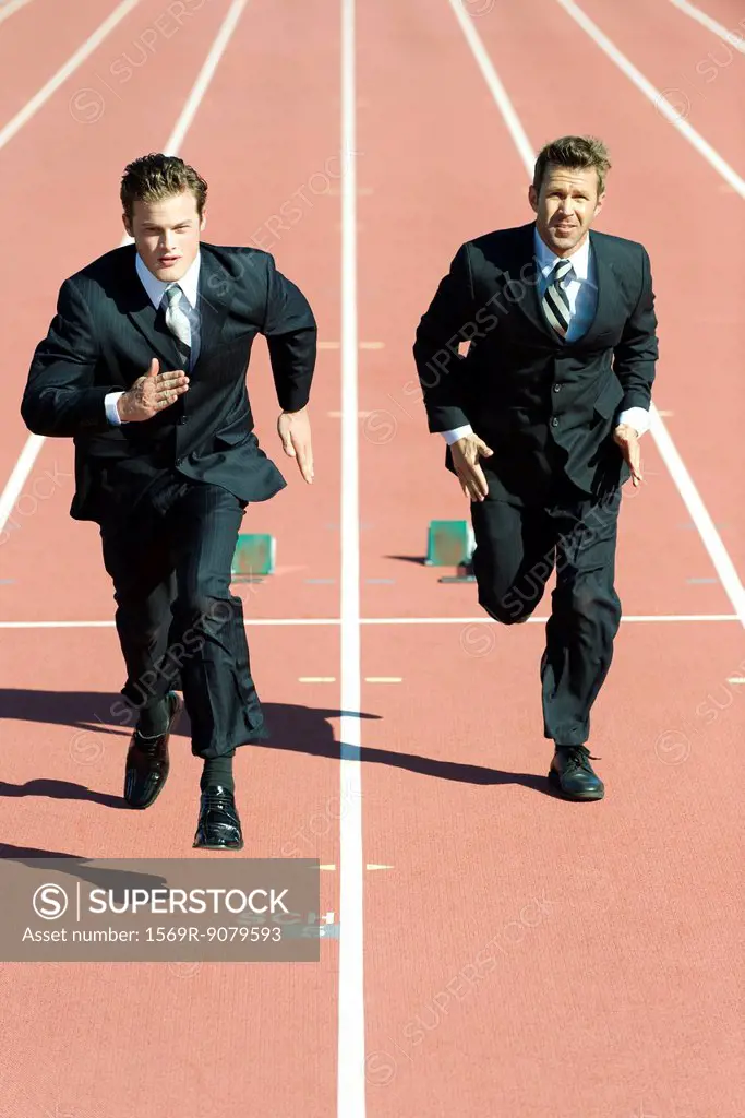 Businessmen racing each other on running track