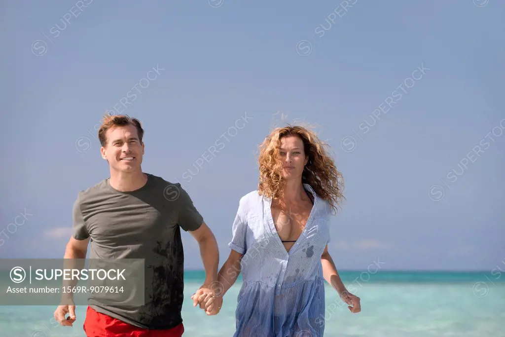 Couple at beach, holding hands