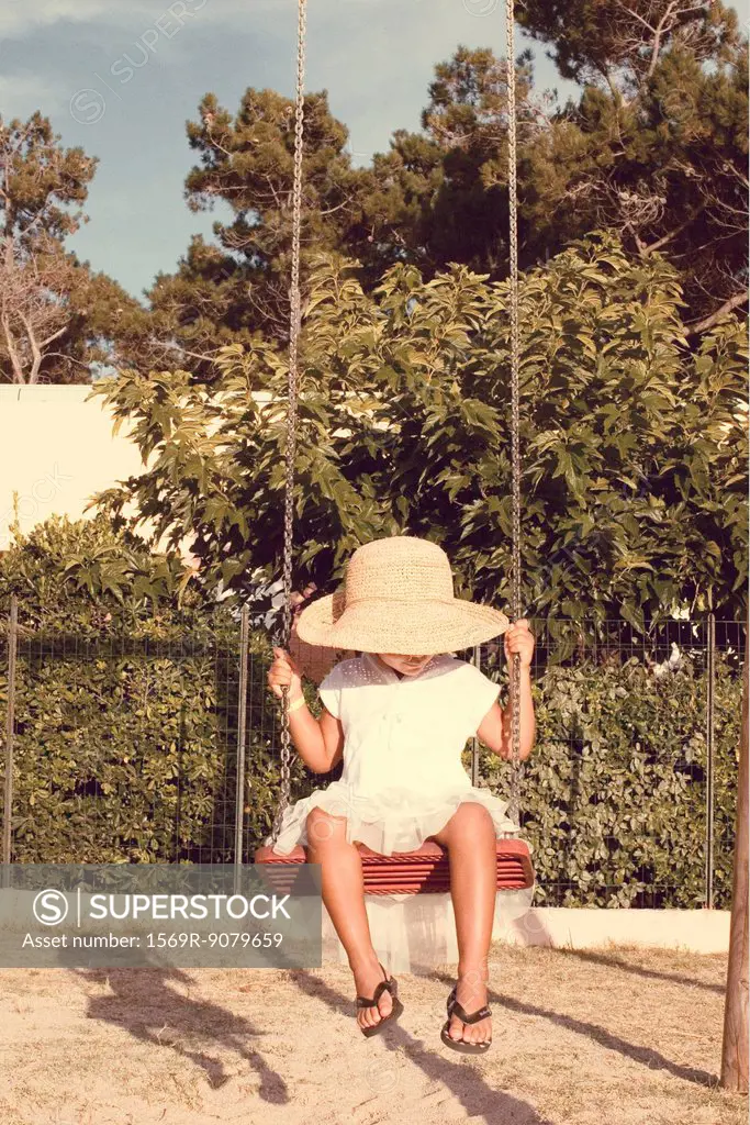 Little girl sitting on swing