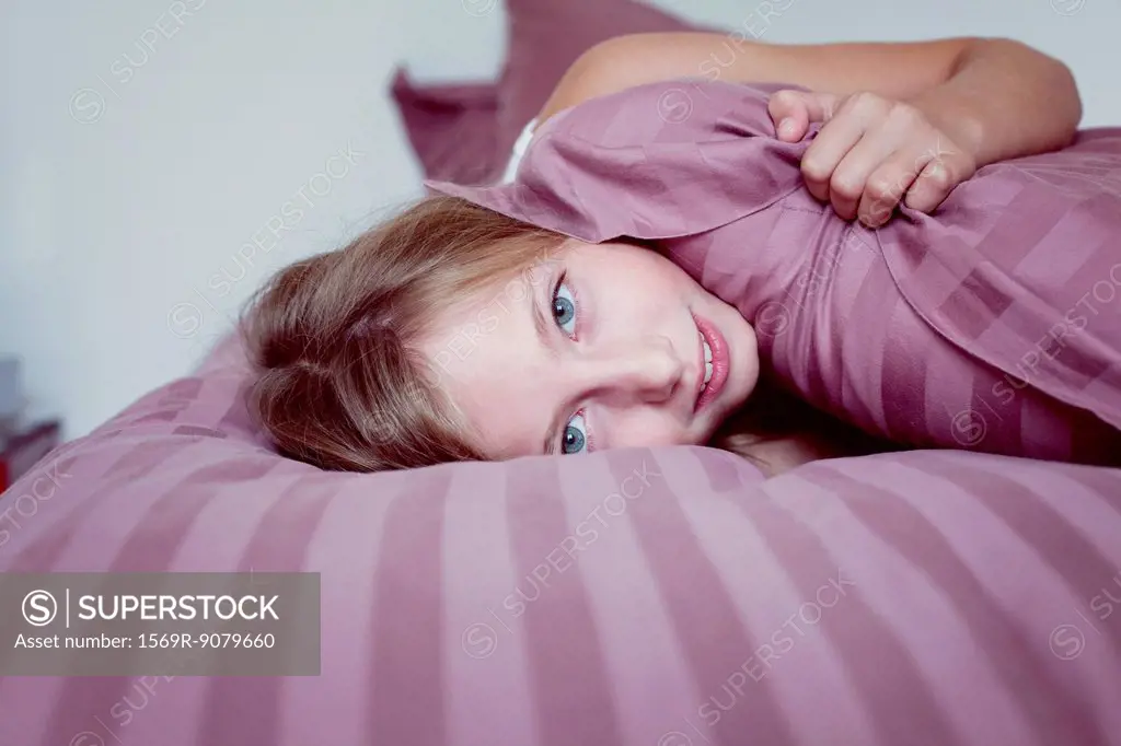 Girl lazing around on bed